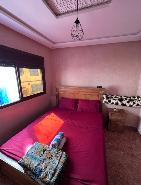 Cozy bedroom with warm pink walls and a wooden bed